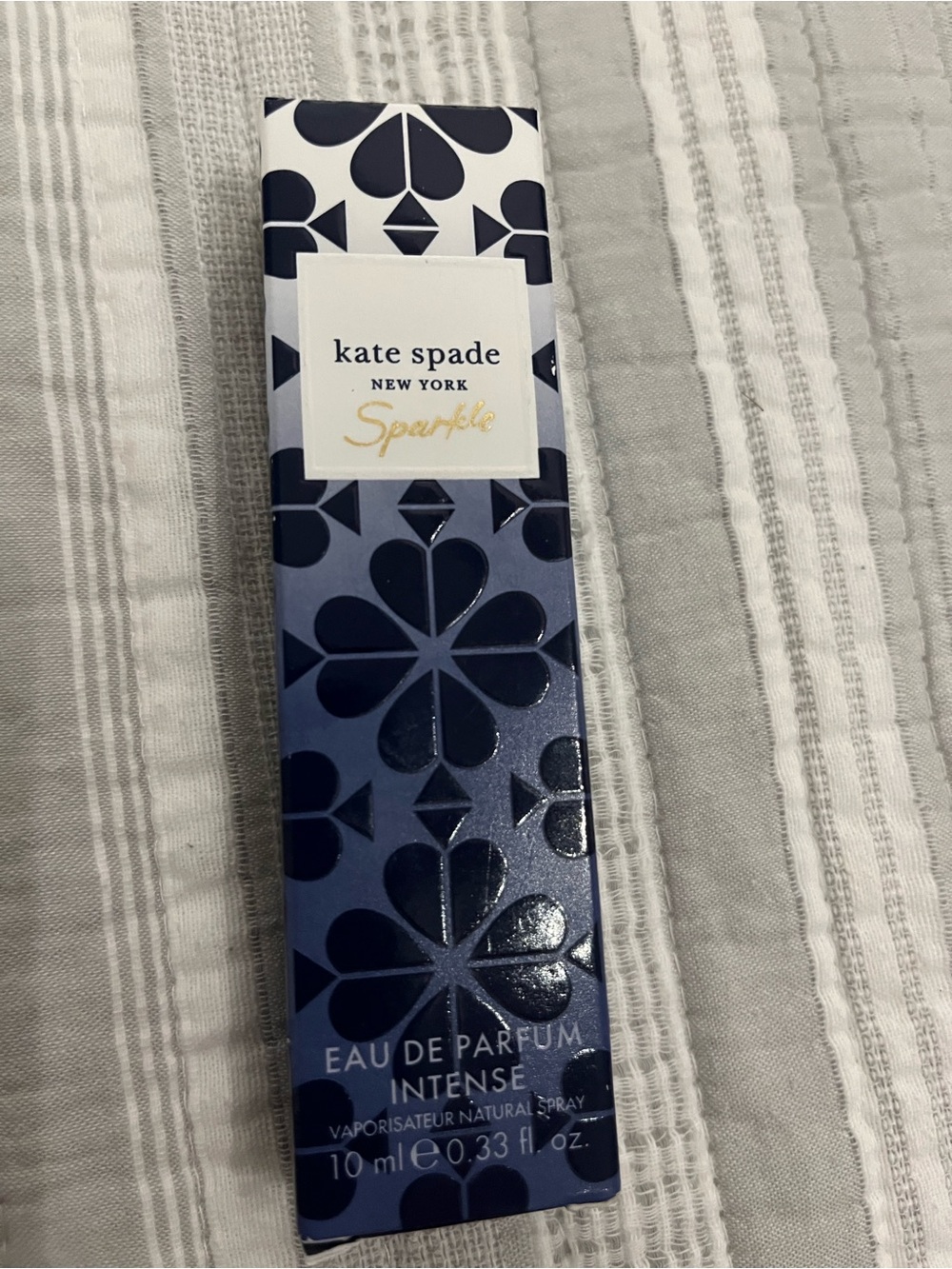 kate spade navy & white patterned perfume . Sparkle is the scent.